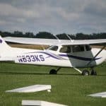 A purple and white plane on a field