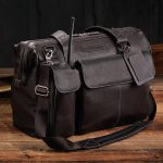 A leather flight bag on a wooden table