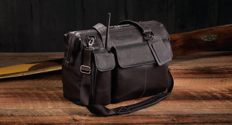 A leather flight bag on a wooden table