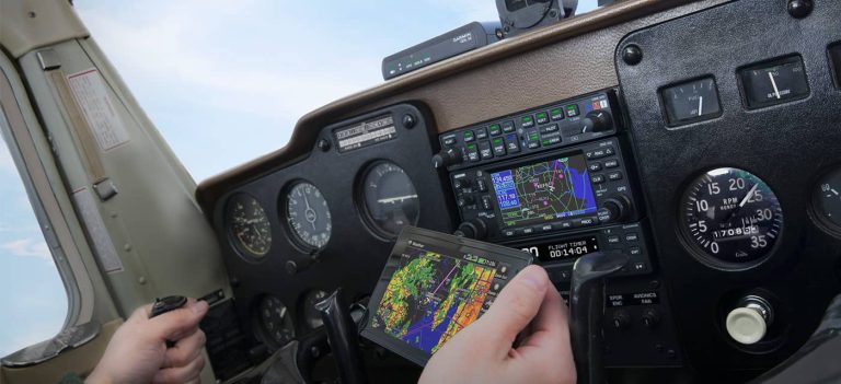 A pilot looking at an ADS-B receiver as he flies