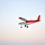 A red and white plane cruising