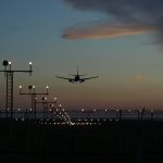 A plane approaching the airport to land at night