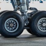 A closeup of airplane tires on a runway