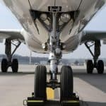 A frontend view of a plane's wheels on a runway