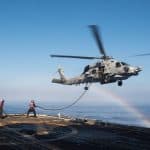 A helicopter flying over an ocean