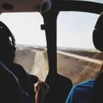 Two pilots sitting inside a helicopter's cockpit