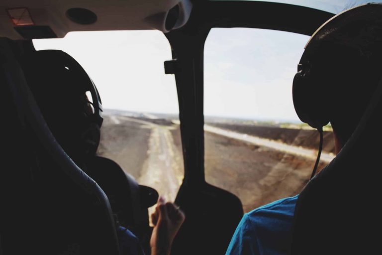 Two pilots sitting inside a helicopter's cockpit