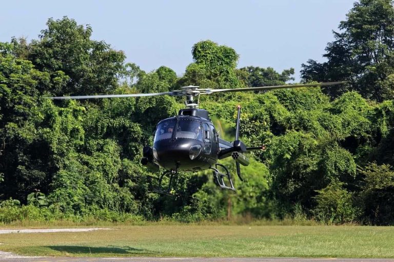 A helicopter landing on a field