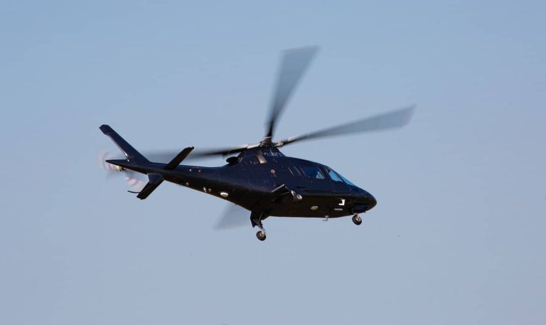 An expensive helicopter flying in calm conditions
