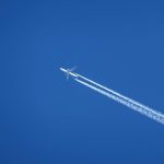 A plane leaving vapor trails behind as it flies