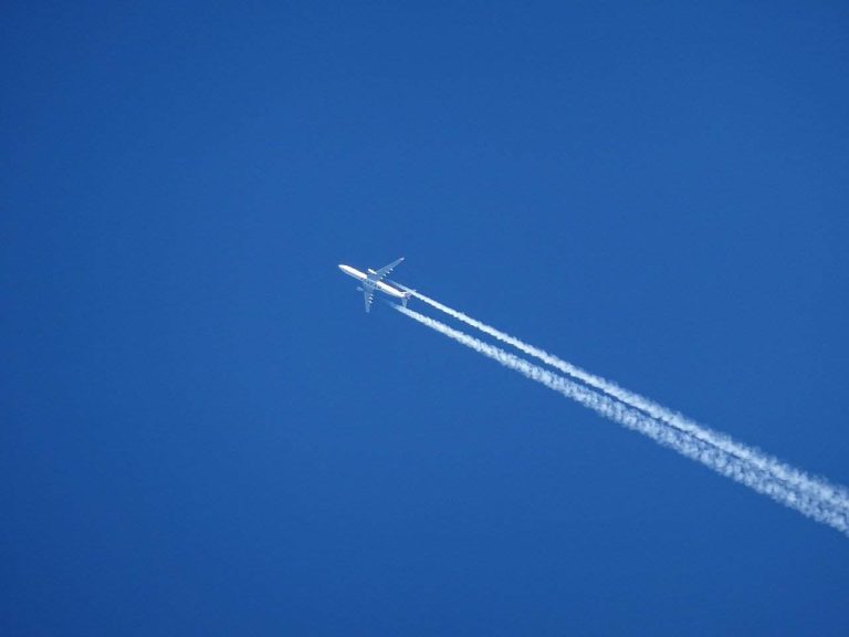 A plane leaving vapor trails behind as it flies