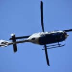 A commercial helicopter flying in blue skies