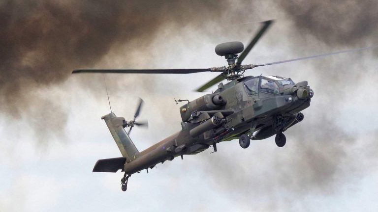 An Apache helicopter flying in the sky
