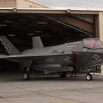 A black Navy plane getting ready to take off