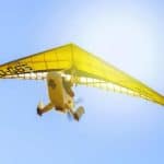 A small yellow plane cruising