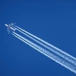 A plane leaving trails as it flies in the sky