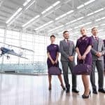 3 female and 2 male flight attendants who are standing