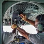 A co-pilot changing controls in the cockpit