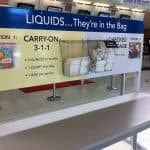 A 3-1-1 liquids rule sign at an airport