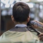 A man getting a haircut with hair clippers