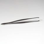 Stainless steel tweezers on a table
