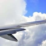 A plane flying with its flaps open