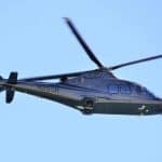 A helicopter flying in blue skies