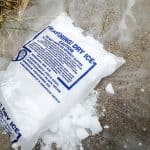A bag of opened dry ice on the ground