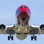 A front-on view of a plane flying in the sky