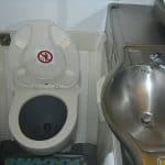 What Really Happens to Your Poop on a Plane An airplane toilet and sink