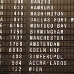 A flight board showing scheduled flights and times