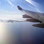 A plane dumping fuel as it cruises in the sky