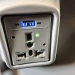 An outlet on the back of a seat on a plane