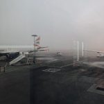 A grounded, delayed plane due to rainy weather conditions