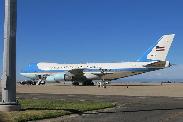 Air Force One parked on a runway in clear skies