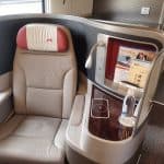 An empty business class seat by a plane's window