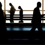 Passengers in a terminal rushing to catch their last minute flight