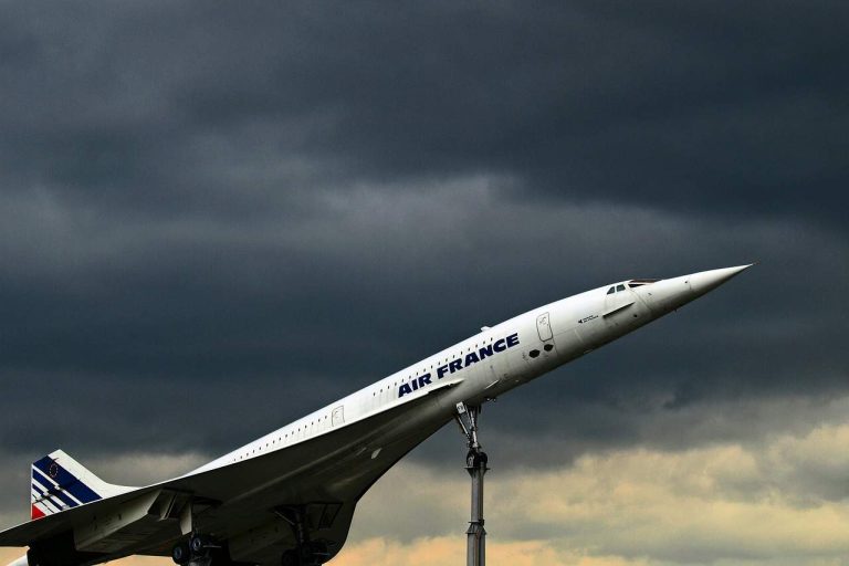 A concorde plane just about to take off in black clouds