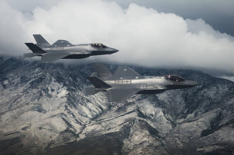 two f-35 fighter jets flying side-by-side