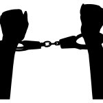 A man in handcuffs who could be a potential flight risk