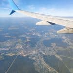 View of a plane's wing and land at 20,000 feet