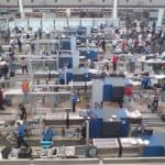TSA officers and passengers going through security screening procedures