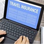 6 Steps to Make a Successful Travel Insurance Claim Man submitting a travel insurance claim on his laptop