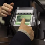 a man having his fingerprints taken at a US airport